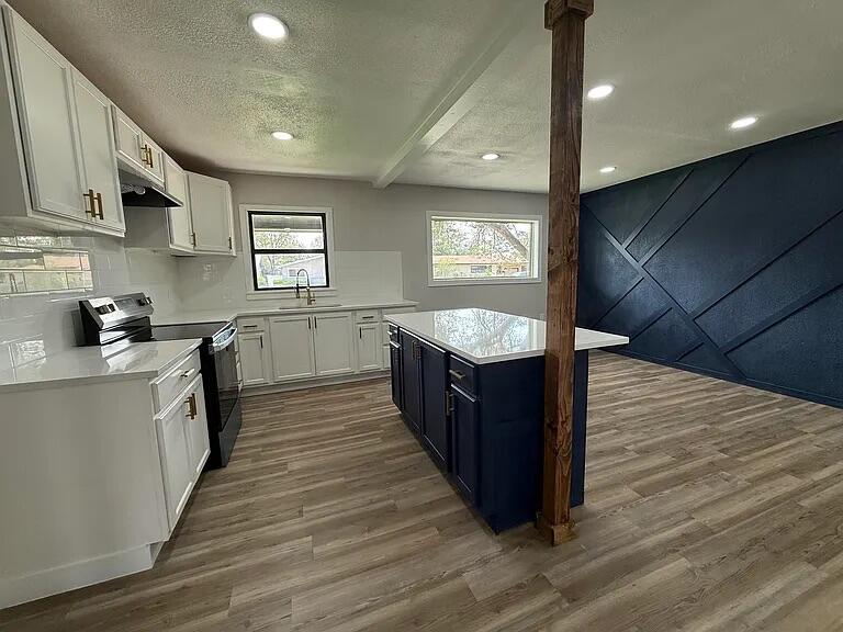 4308 43rd Street Lubbock, TX 79413 - Photo 7 of 18 a large kitchen with stainless steel appliances granite countertop a large counter top a stove a sink and a refrigerator