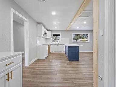 4308 43rd Street Lubbock, TX 79413 - Photo 9 of 18 a room with wooden floors and kitchen view