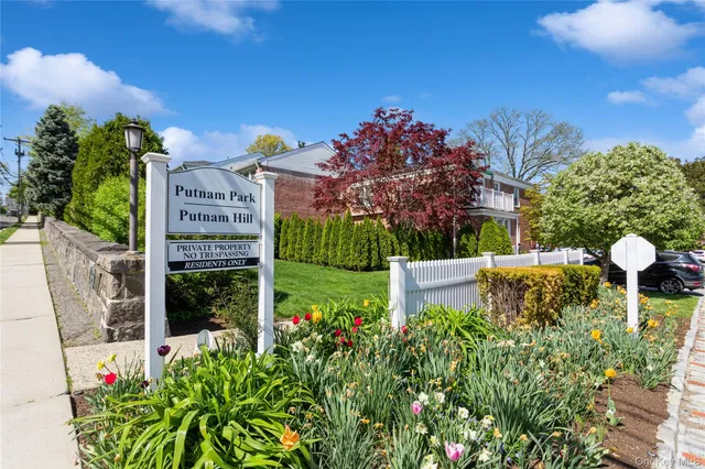 a view of a house with a yard and garden