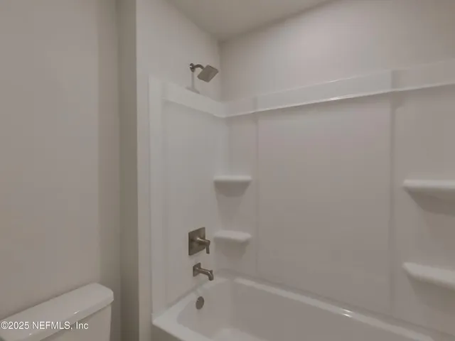 a bathroom with a bathtub and toilet