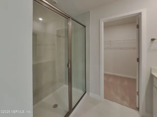 a bathroom with a glass shower door