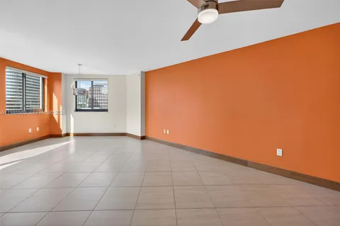 a kitchen with a refrigerator and cabinets