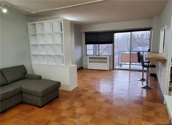 a living room with furniture and a large window