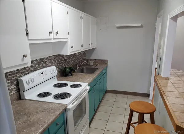 a kitchen with a stove and a refrigerator