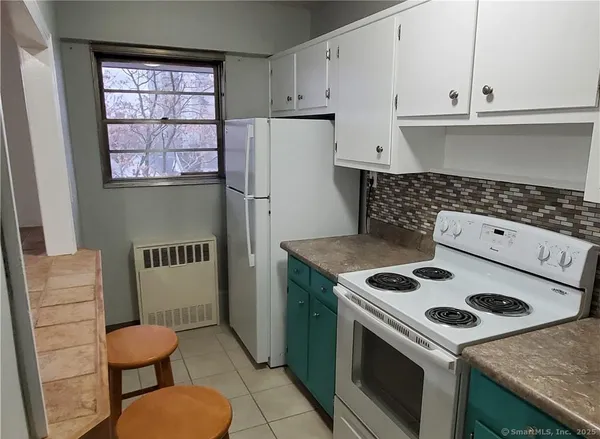 a kitchen with a stove a refrigerator and a cabinets