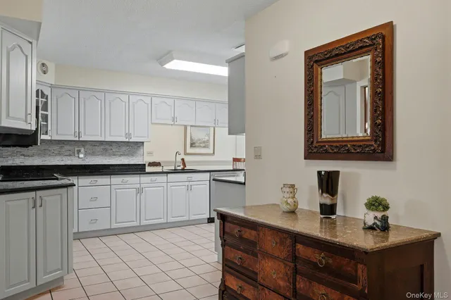 a kitchen with a sink cabinets and wooden floor