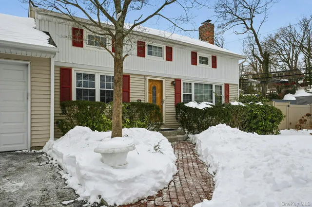 a view of a house with a yard and sitting area