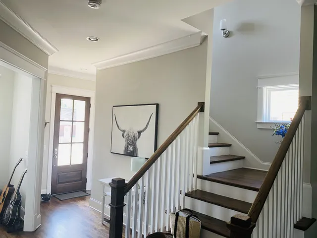 a view of entryway and hall with wooden floor