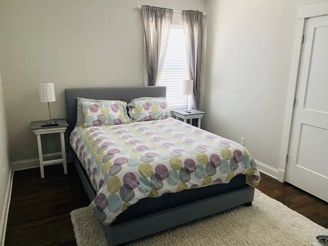 a bed sitting in a bedroom next to a window