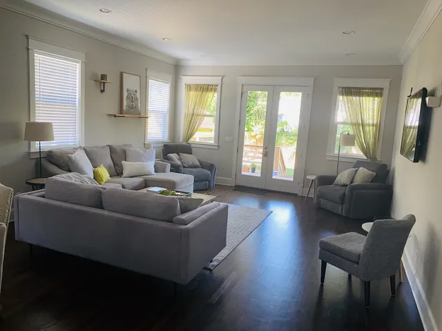 a living room with furniture and a wooden floor