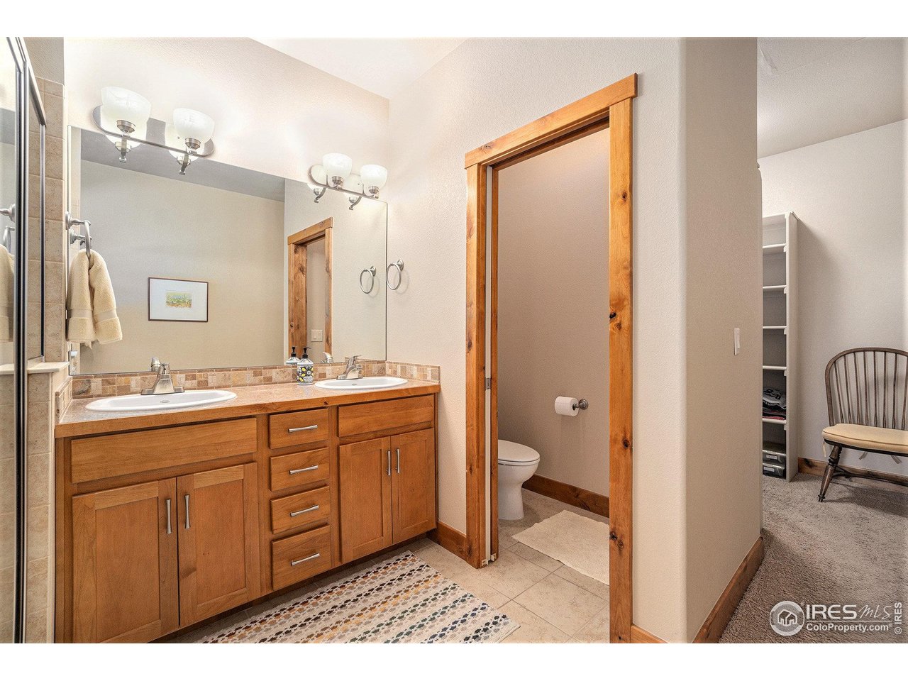 1827 Fromme Prairie Way Fort Collins, CO 80526 - Photo 12 of 21 a bathroom with a sink a toilet a mirror and shower
