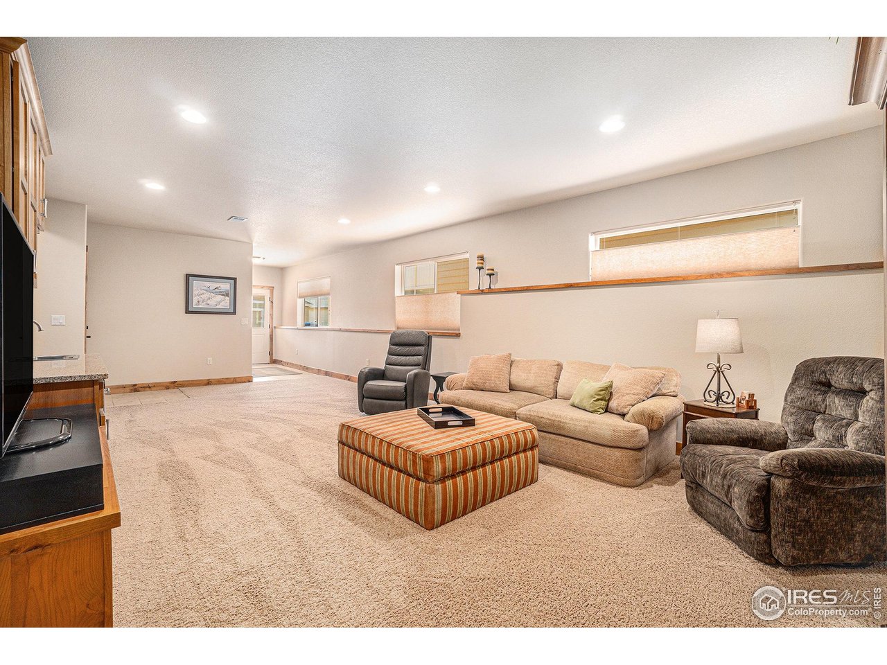 1827 Fromme Prairie Way Fort Collins, CO 80526 - Photo 16 of 21 a living room with furniture and a flat screen tv