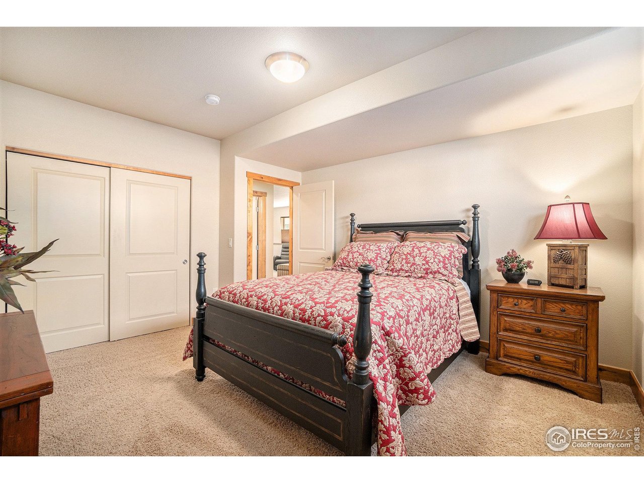 1827 Fromme Prairie Way Fort Collins, CO 80526 - Photo 17 of 21 a spacious bedroom with a bed a lamp and a large window