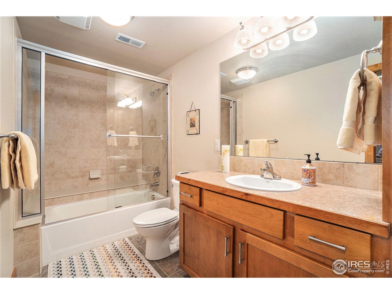 1827 Fromme Prairie Way Fort Collins, CO 80526 - Photo 18 of 21 a bathroom with a granite countertop sink toilet and shower