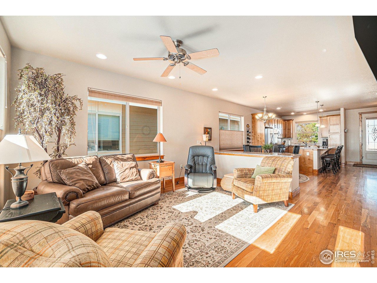 1827 Fromme Prairie Way Fort Collins, CO 80526 - Photo 3 of 21 a living room with furniture and a wooden floor