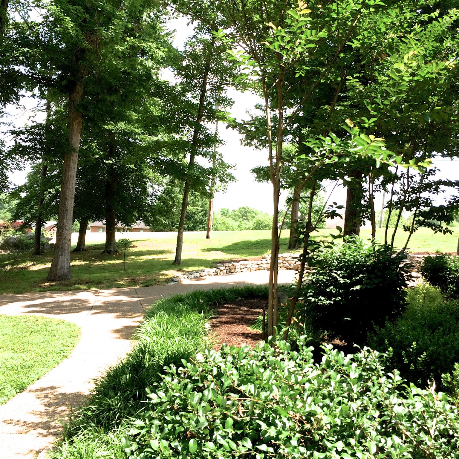 1037 Rock Church Road Dickson, TN 37055 - Photo 1 of 15 Lush wooded lot with gorgeous aggregate sidewalks and perennial flower beds!
