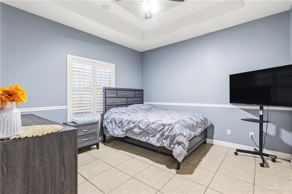 22602 Rio Rancho Road Harlingen, TX 78552 - Photo 11 of 26 a bedroom with a bed and a flat tv screen on dresser