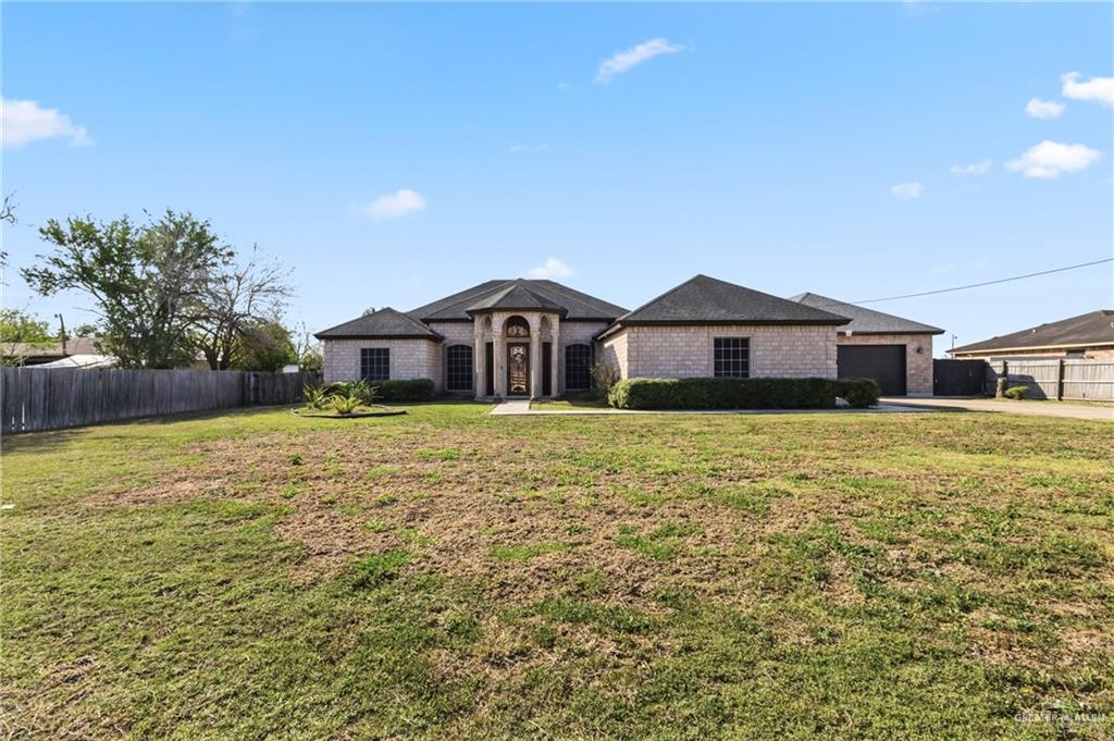 22602 Rio Rancho Road Harlingen, TX 78552 - Photo 2 of 26 a front view of a house with garden