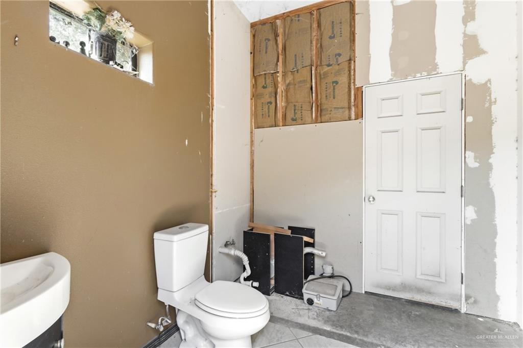 22602 Rio Rancho Road Harlingen, TX 78552 - Photo 21 of 26 a white toilet sitting next to a bathroom