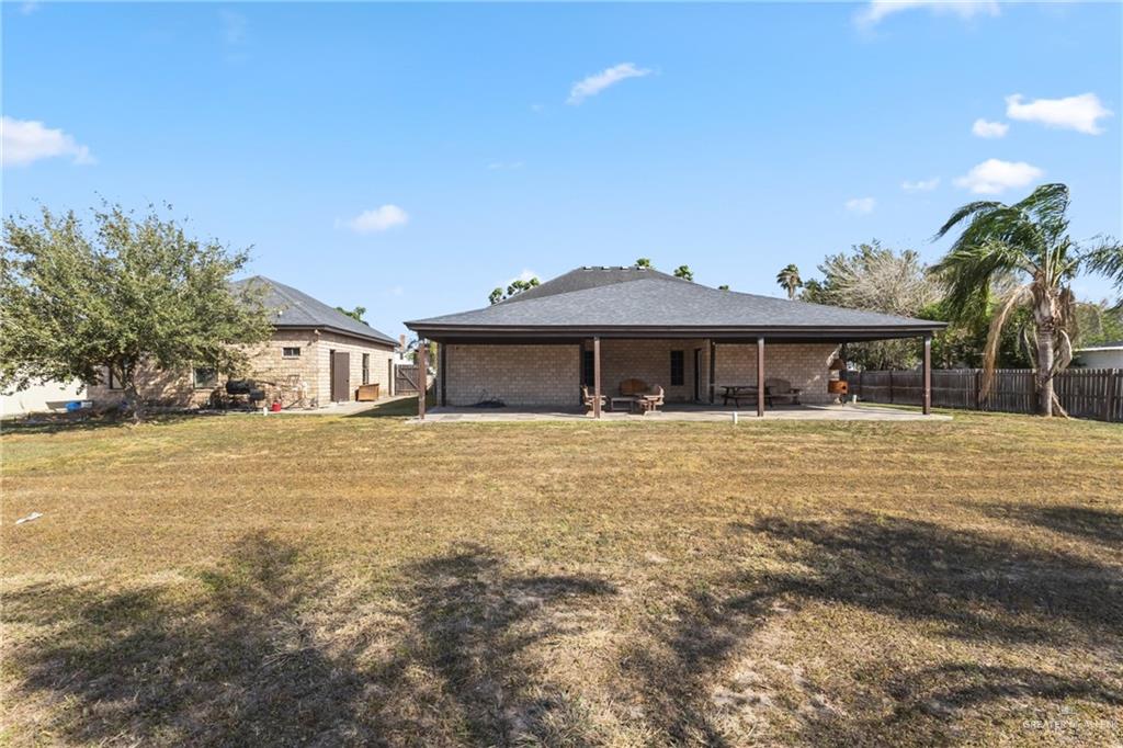 22602 Rio Rancho Road Harlingen, TX 78552 - Photo 22 of 26 a front view of a house with a garden