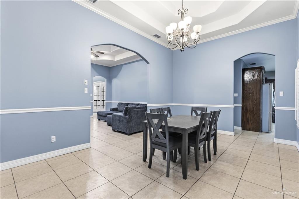 22602 Rio Rancho Road Harlingen, TX 78552 - Photo 7 of 26 a view of a dining room with furniture and chandelier