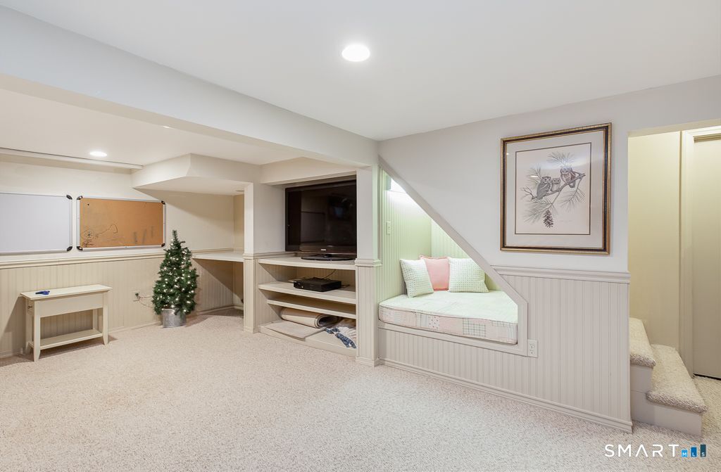 13 Dock Road Milford, CT 06460 - Photo 14 of 18 a living room with furniture a couch and a flat screen tv