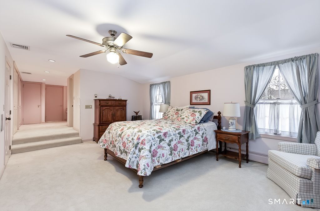 13 Dock Road Milford, CT 06460 - Photo 16 of 18 a bed room with a bed and a chandelier