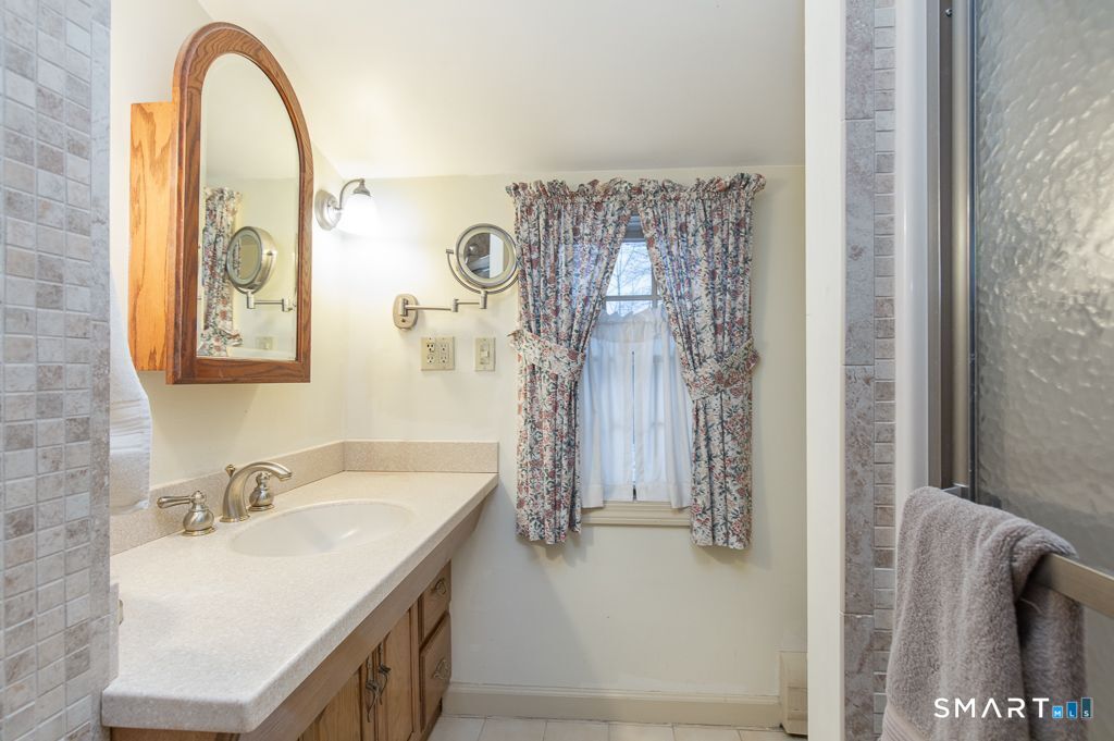 13 Dock Road Milford, CT 06460 - Photo 18 of 18 a bathroom with a sink and a mirror