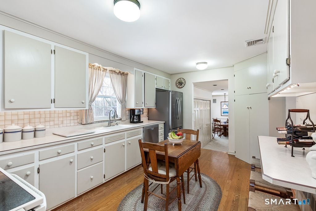 13 Dock Road Milford, CT 06460 - Photo 7 of 18 a kitchen with a sink stove and cabinets