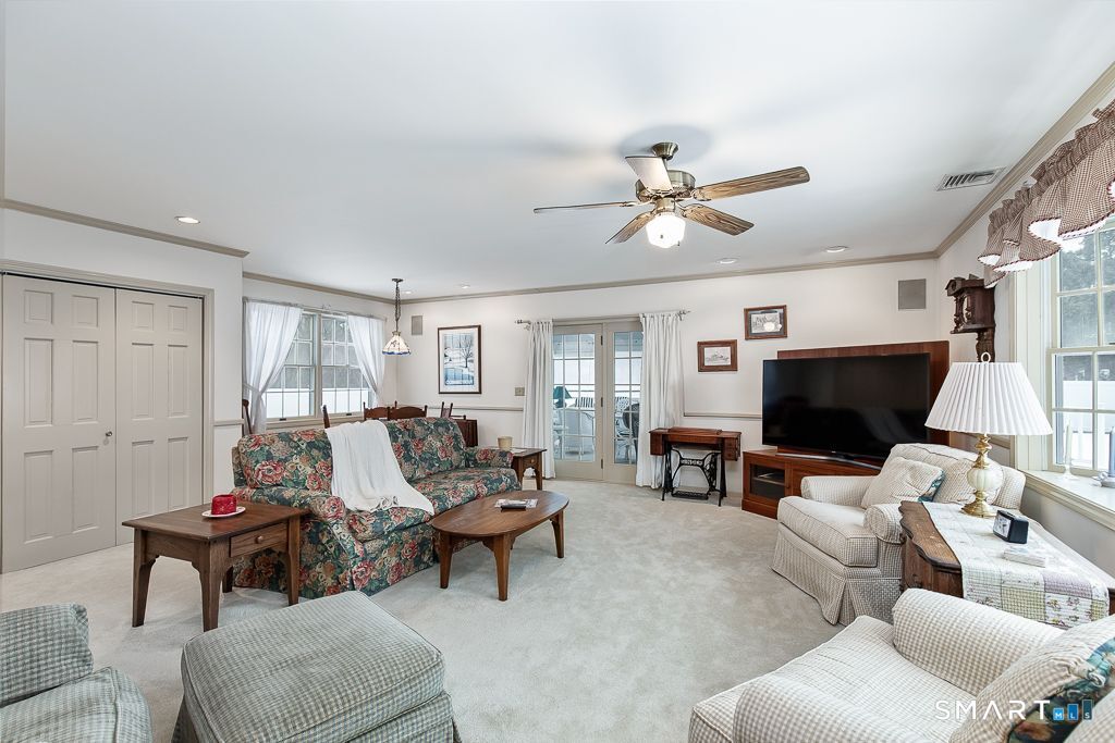 13 Dock Road Milford, CT 06460 - Photo 8 of 18 a living room with furniture a fireplace and a window