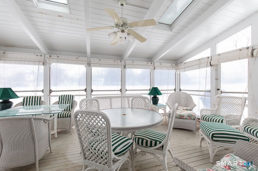 13 Dock Road Milford, CT 06460 - Photo 9 of 18 a dining room with furniture a chandelier and wooden floor