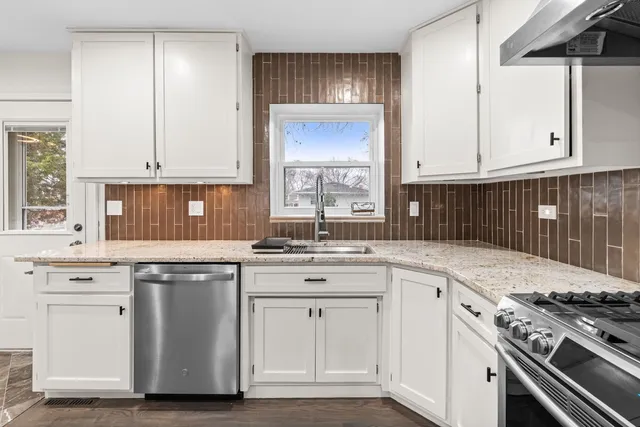 a kitchen with white cabinets and white appliances