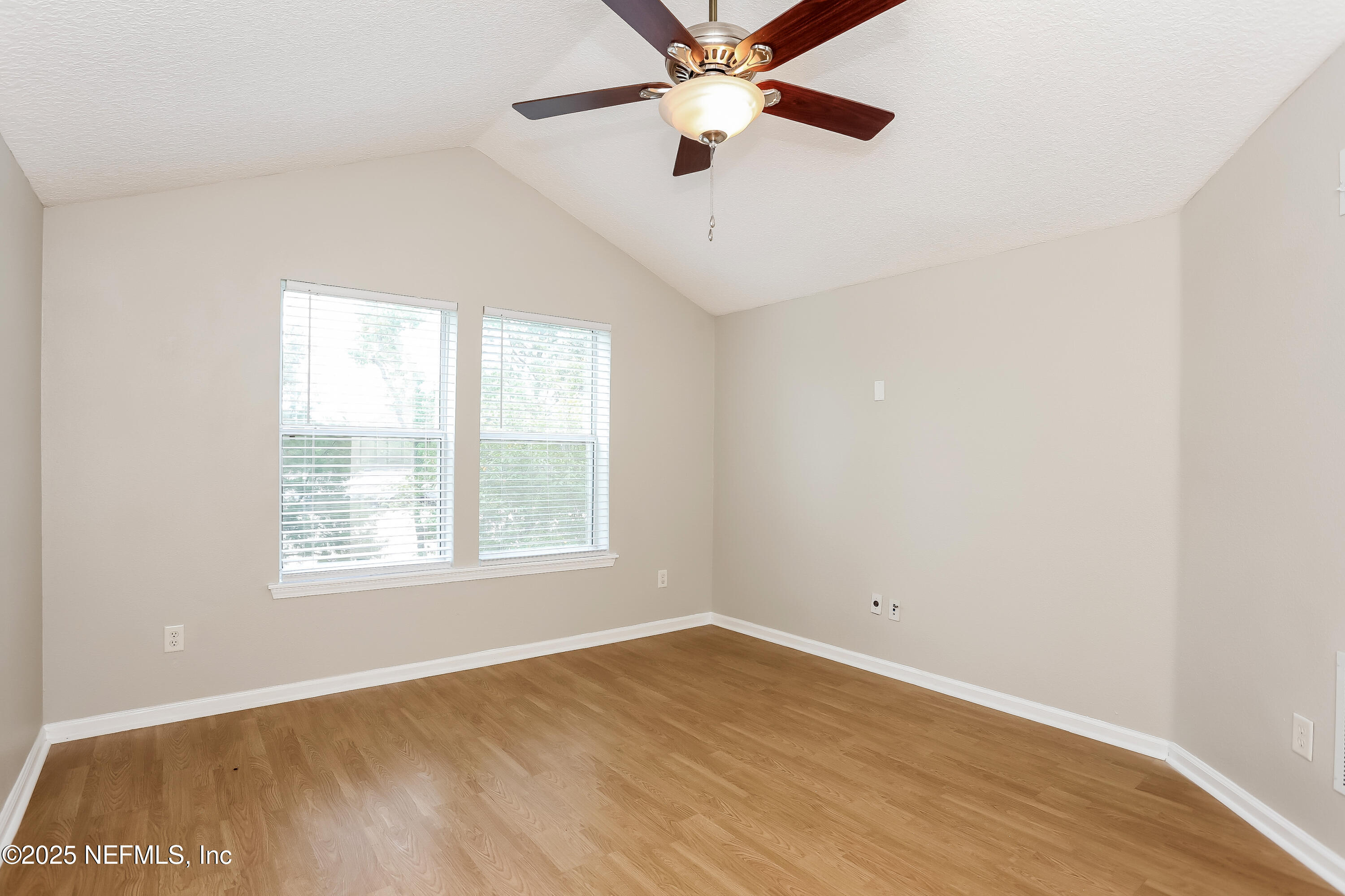 15808 Spotted Saddle Circle Jacksonville, FL 32218 - Photo 15 of 18 an empty room with wooden floor fan and windows
