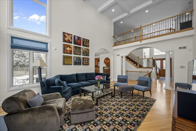 a living room with furniture a rug and a window