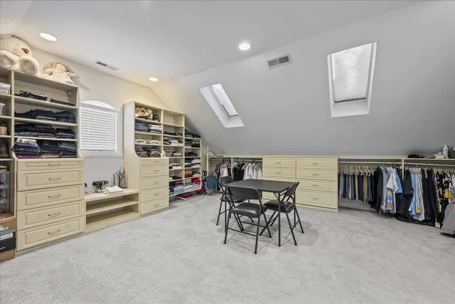 a bedroom with a bed chair and window