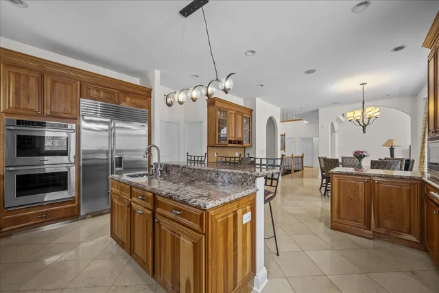 a kitchen with stainless steel appliances granite countertop a stove oven and a refrigerator