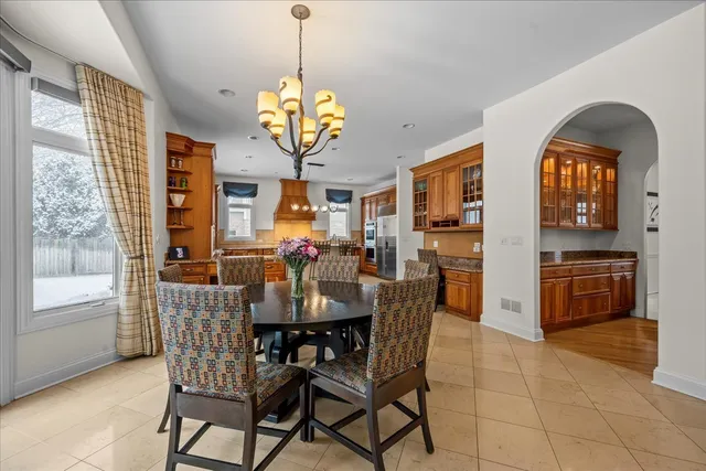 a view of a dining room with furniture and chandelier