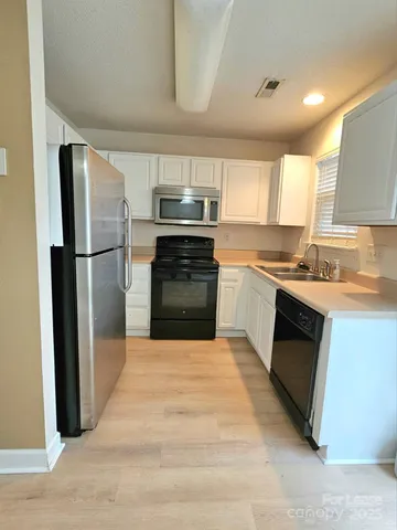 a kitchen with a refrigerator stove and microwave