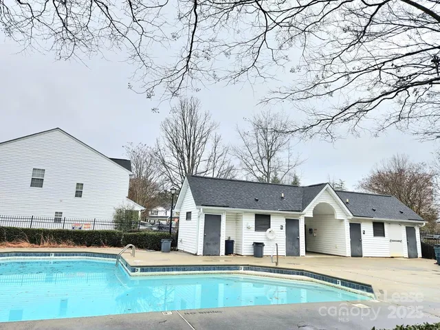a view of a white house with a big yard and large tree