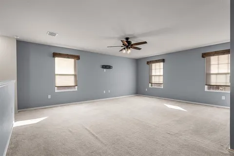 a view of an empty room with windows