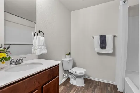a bathroom with a sink toilet and mirror