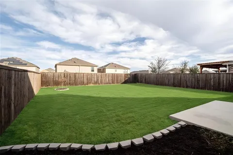 a view of a backyard with sitting area