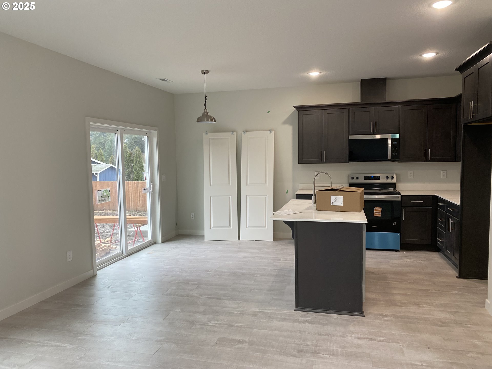 175 West 8th Street Lafayette, OR 97127 - Photo 5 of 6 a kitchen with kitchen island stainless steel appliances a sink cabinets and a wooden floor