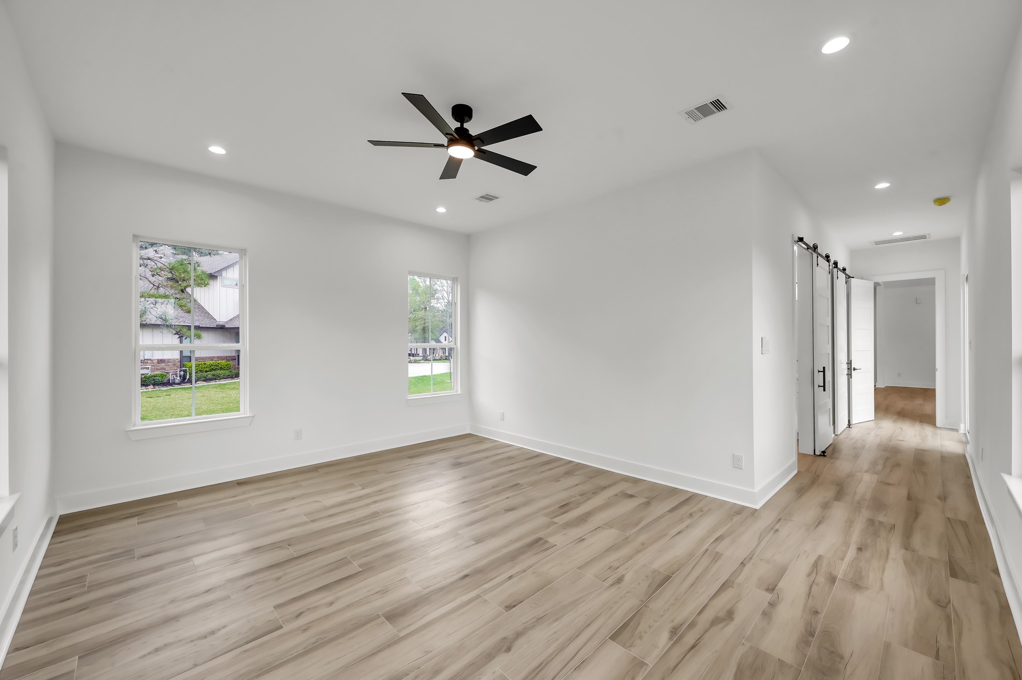14742 Turquoise Trail Willis, TX 77378 - Photo 25 of 48 Another view of the generous primary suite highlighting the spacious layout and seamless connection to the private bath and hallway.