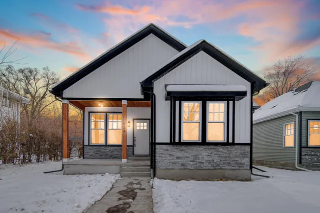 a front view of a house with large windows
