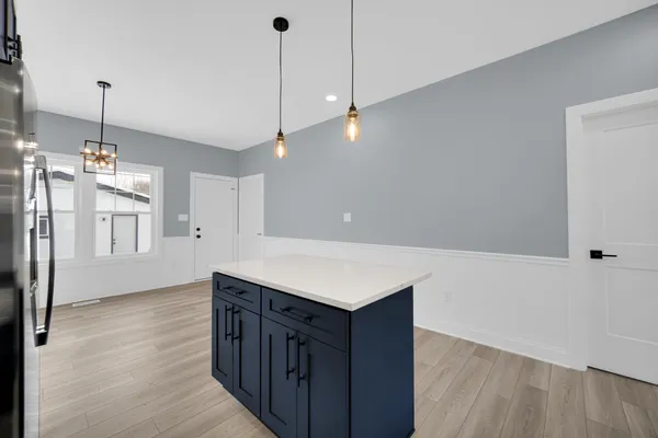 a kitchen with wooden floor and window