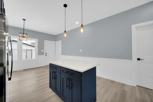 a kitchen with wooden floor and window
