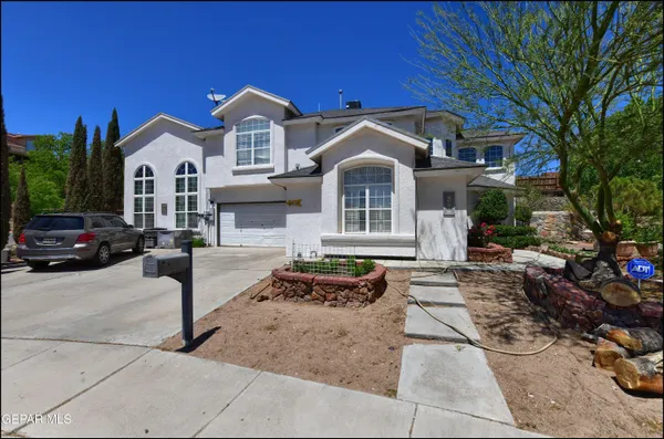 a front view of a house with parking space