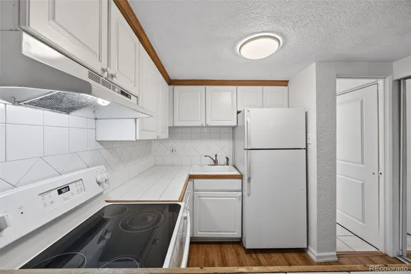 a kitchen with a refrigerator and a stove