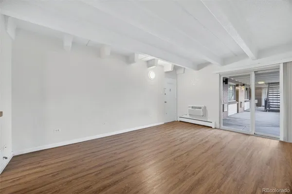 a view of an empty room and wooden floor